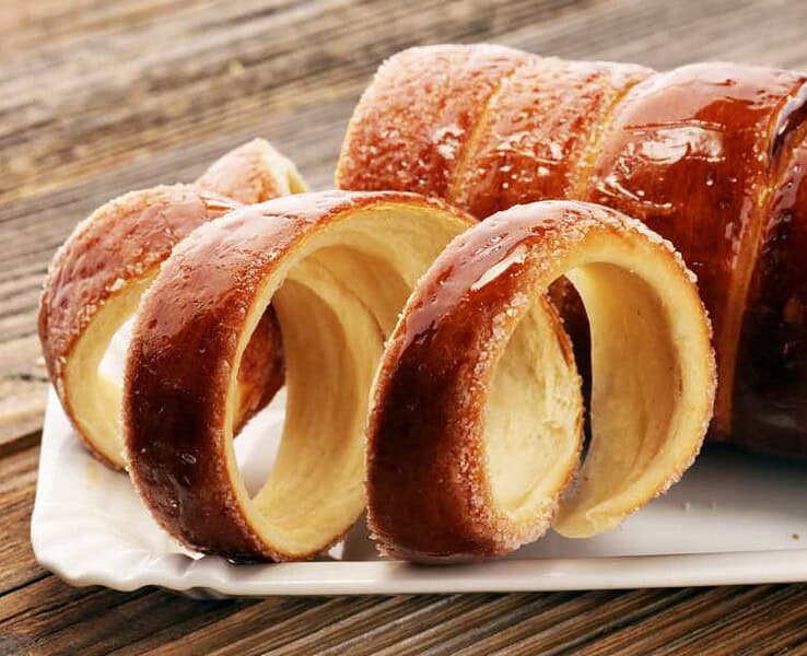 Chimney Cake Magic: Experience the Irresistible Delight of Kürtőskalács! Discover the top destinations to savor this delectable treat.